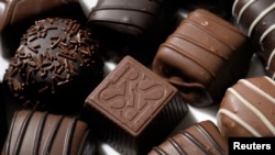 FILE - A light almond cream chocolate candy carries the initials for Russell Stover Candies as shown in Kansas City, Kansas, July 14, 2014.