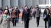 Pedestrians wear face masks to help prevent the spread of the coronavirus, April 1, 2020, in Pyongyang, North Korea. 