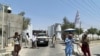 Taliban fighters stand guard at an entrance gate outside the Interior Ministry in Kabul, August 17, 2021.