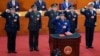 2018年3月18日，新一届中国国家中央军委大部分成员在北京人民大会堂宣誓就职。排名第一的副主席许其亮手抚宪法，后排从左到右：委员张升民、李作成、副主席张又侠、委员魏凤和、苗华。