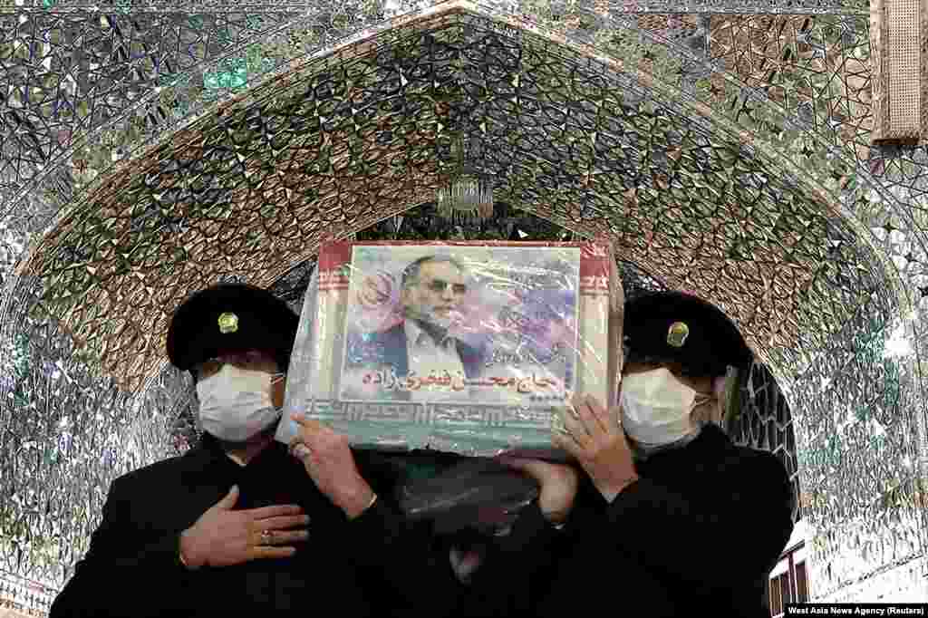 Servants of the holy shrine of Imam Reza carry the coffin of Iranian nuclear scientist Mohsen Fakhrizadeh, in Mashhad.