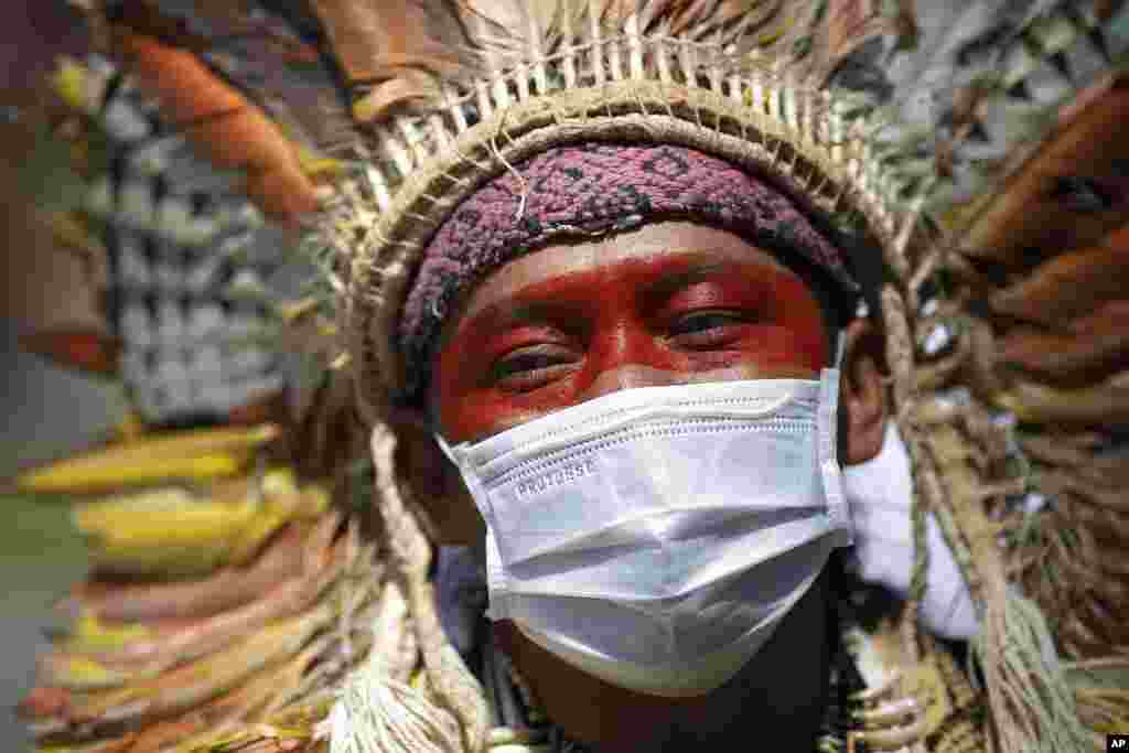 Ninawa Inu Huni kui, 40, protests against auctions for the exploration of oil fields in the Amazons outside an hotel in Rio de Janeiro, Brazil.