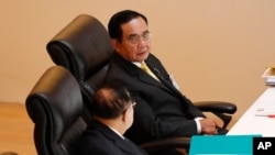 Thailand's Prime Minister Prayuth Chan-ocha, top, talks to Deputy Prime Minister Prawit Wongsuwan during the special session at the parliament in Bangkok, Thailand, Monday, Oct. 26, 2020. Thailand's Parliament began a special session Monday that was…