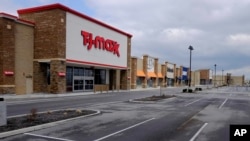  An empty parking lot is seen at retail stores are closed, Wednesday, April 15, 2020, in Whitestown, Indiana.
