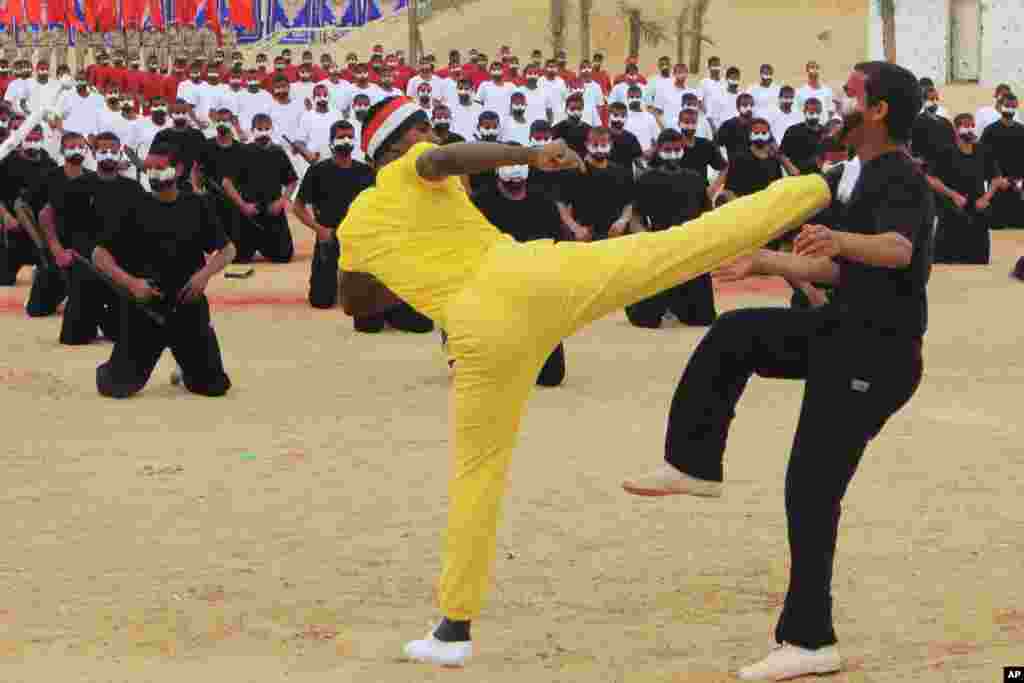 Egyptian security forces members demonstrate their skills during a ceremony in Cairo. Egypt's Interior Minister Mohammed Ibrahim observed a parade, feasts and training strategies used by security forces during the ceremony, March 23, 2014.