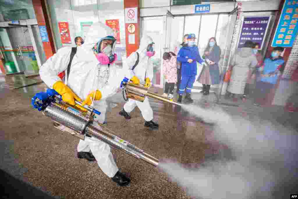 Workers disinfecting a bus station in Bijie, in China's southwest Guizhou province, as authorities prepare for a travel peak ahead of the Lunar New Year, which ushers in the Year of the Ox.