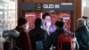 FILE - People watch a broadcast report about Lee Man-hee, a leader of Shincheonji Church of Jesus, at the Seoul Railway Station in Seoul, South Korea, March 2, 2020. Man-hee apologized for causing the "unintentional" spread of COVID-19.