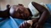 FILE - A young girl with malaria rests in the inpatient ward of the Malualkon Primary Health Care Center in Malualkon, in the South Sudanese state of Northern Bahr el Ghazal, June 1, 2012.