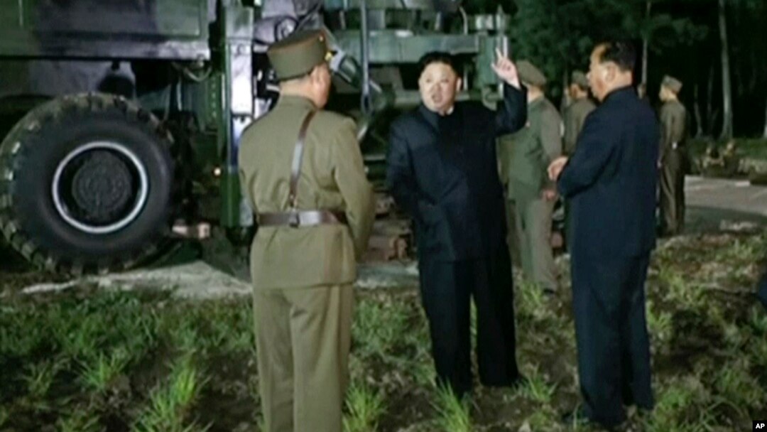 In this image made from video by North Korea's KRT, July 28, 2017, North Korean leader Kim Jong Un gestures at the site of a missile test at an undisclosed location in North Korea.