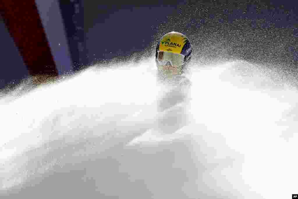 Austria's Tamara Tippler is engulfed in snow as she gets to the finish line after completing an alpine ski, women's World Cup downhill, in Val d'Isere, France.