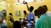 FILE - A doctor looks at an X-ray of a victim of violence in the crackdown on Sudanese protesters, inside a ward in a hospital in Omdurman, Khartoum, Sudan, June 10, 2019.