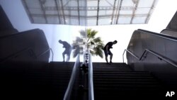A man looks down a stairway at a shuttered Metro station in Athens, as Metro workers are on 24 -hour strike to protest staff and material shortages, on May 14, 2018. 