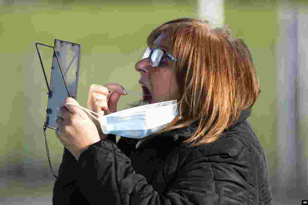A member of the public swabs herself on the first day of the pilot scheme of mass testing in Liverpool. Liverpool is the pilot project for possible weekly testing of the entire population, covering up to 10 million people across England a day.