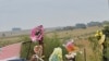 A supporter of African far-right leader Euguene Terre'Blanche looks at flowers and pays tribute in front of the entrance of the farm in Ventersdorp, 05 Apr 2010