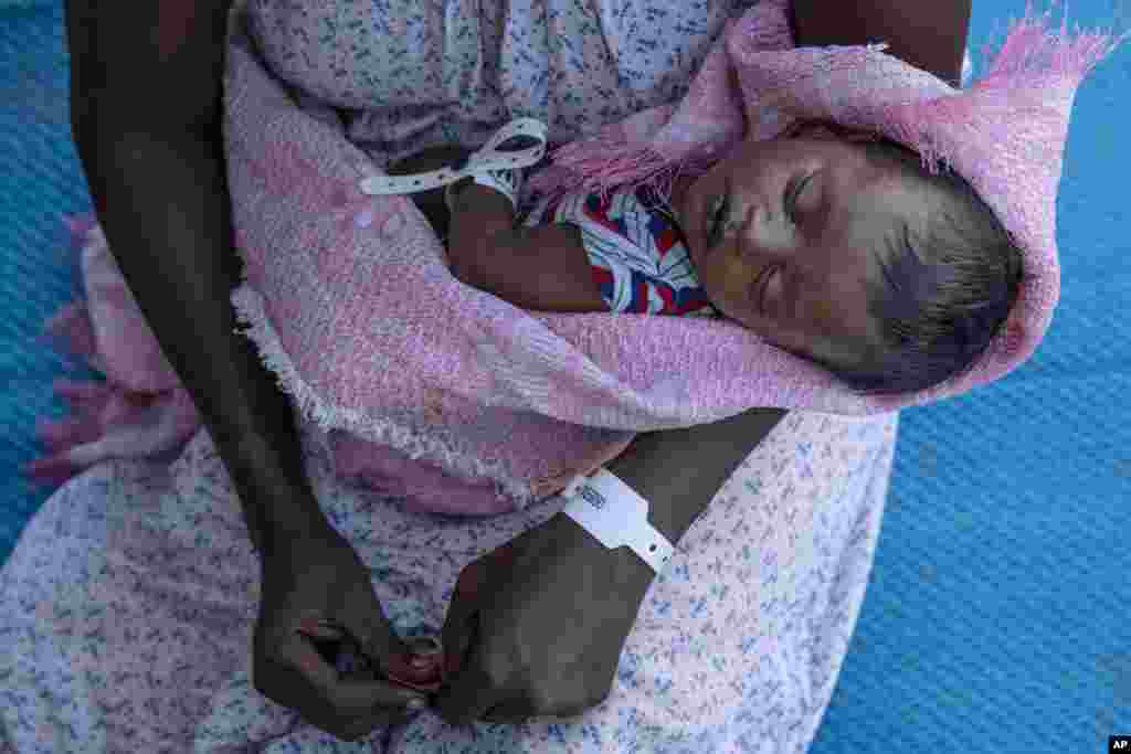Terhas Tsfa, 25, who gave birth on a street as she fled the conflict in Ethiopia's Tigray region, holds her baby at Um Rakuba refugee camp in Qadarif, eastern Sudan, Nov. 23, 2020.