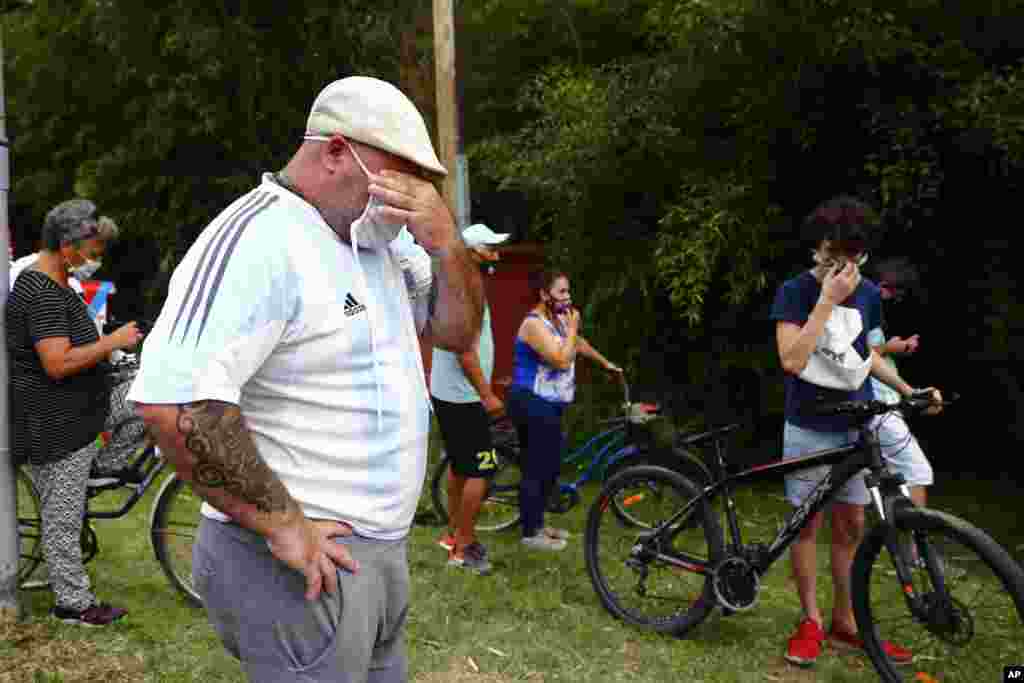Mourners gather outside the home of Diego Maradona, in Buenos Aires, Argentina. The Argentine soccer great who was among the best players ever and who led his country to the 1986 World Cup title, died from a heart attack at his home in. He was 60. 