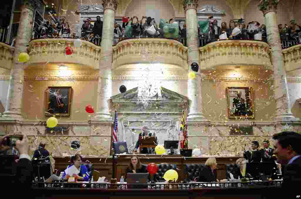 Pages drop confetti and balloons from a balcony in the Maryland House of Delegates chamber in Annapolis, Maryland, USA, to celebrate the end of the state's 2018 legislative session.