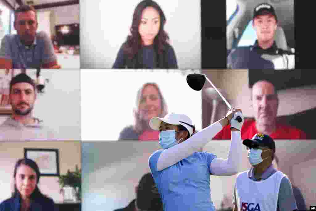 Jing Yan of China hits off the first tee as virtual fans look on during the first round of the U.S. Women's Open golf tournament in Houston, Texas.