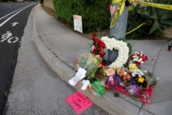 FILE - A makeshift memorial was placed by a light pole a block away from a shooting incident where one person was killed at the Congregation Chabad synagogue in Poway, north of San Diego, California, Apr. 27, 2019.