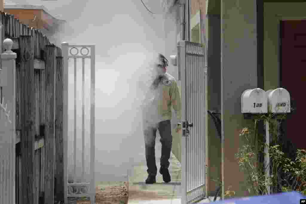 A Miami-Dade County mosquito control worker sprays around a home in the Wynwood area of Miami, Florida. The Center for Disease Control and Prevention has issued a new advisory that says pregnant women should not travel a Zika-stricken part of Miami.