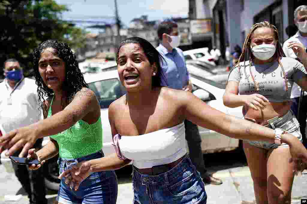 People with hospitalized relatives watch firefighters battle a blaze at the Bonsucesso Federal Hospital in Rio de Janeiro, Brazil. According to the fire department, there were no casualties.