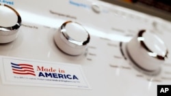 FILE - A General Electric washing machine with a label advertising it was made in America is displayed in a retail store in Cranberry Township, Pennsylvania, May 9, 2019. 
