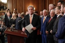 FILE - House Minority Leader Kevin McCarthy, center, is joined by fellow Republican lawmakers as he walks up to the podium to begin speaking during a news conference on Capitol Hill in Washington, Oct. 31, 2019.