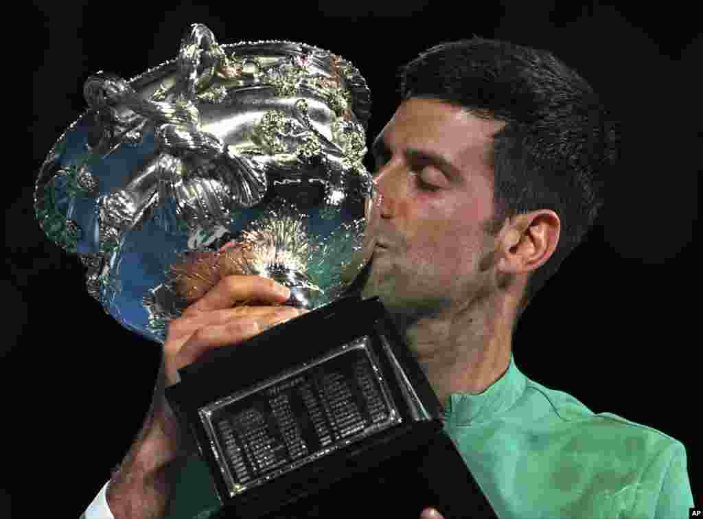 Serbia's Novak Djokovic kisses the Norman Brookes Challenge Cup after defeating Russia's Daniil Medvedev in the men's singles final at the Australian Open tennis championship in Melbourne, Australia.