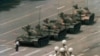 FILE - A Chinese man stands alone to block a line of tanks heading east on Beijing's Cangan Boulevard in Tiananmen Square, in early June 1989. 
