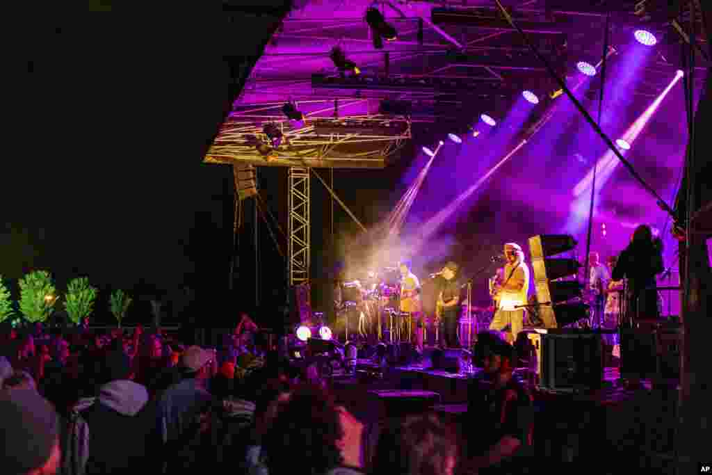 People watch New Zealand band The Black Seeds perform during New Year's Eve celebrations at Hagley Park in Christchurch, New Zealand, Jan. 1, 2021.