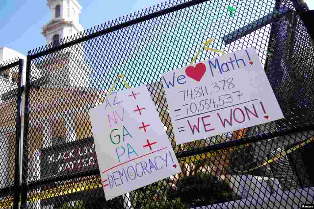 Posters displaying election results hang on the fence outside of St. John's Church near the White House in Washington, D.C., after a presidential election victory was called for former Vice President Joe Biden.