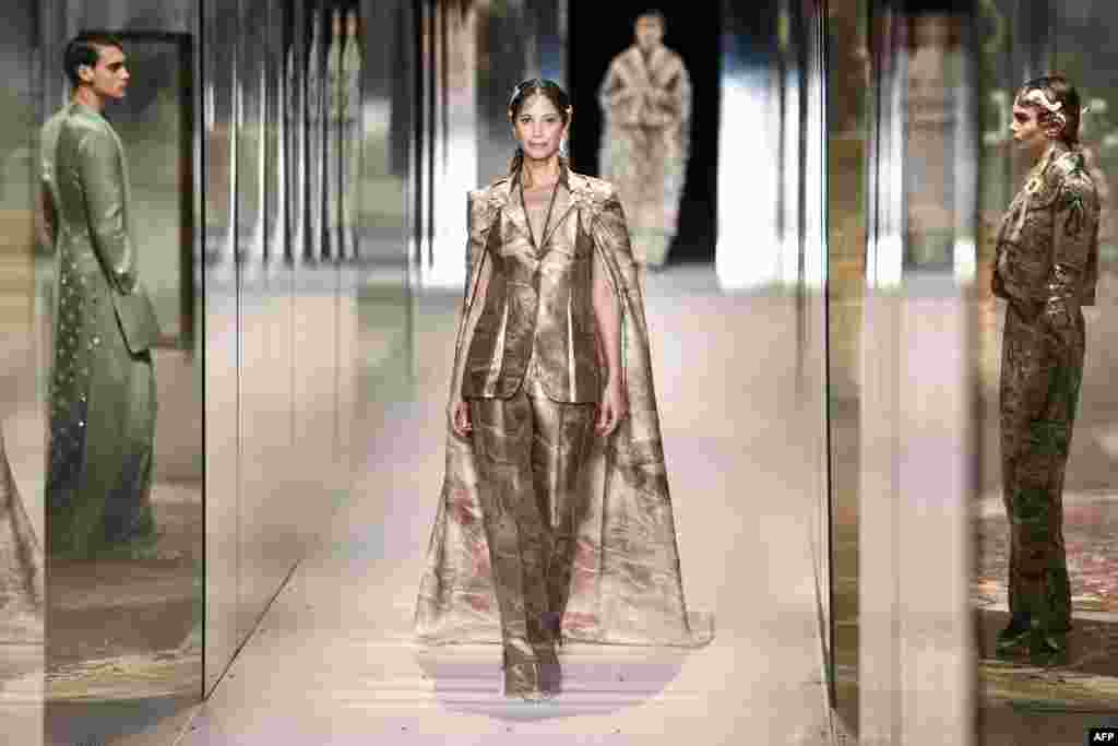 American model Christy Turlington presents a creation of British designer Kim Jones for the Fendi's Spring-Summer 2021 collection during the Paris Haute Couture Fashion Week, in Paris, France.