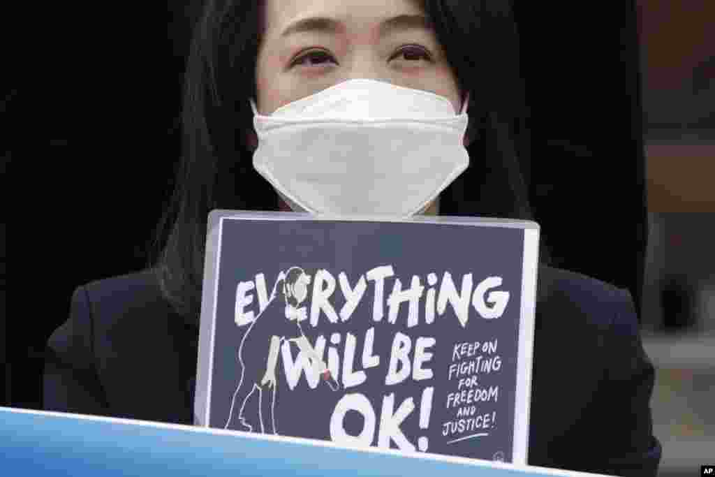 A South Korean lawmaker Choi Hye Young holds a sign during a news conference supporting Myanmar's democracy in front of the Myanmar Embassy in Seoul.