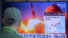 A man watches a TV screen showing a file image of North Korea's missile launch during a news program at the Seoul Railway Station in Seoul, South Korea, March 29, 2020.