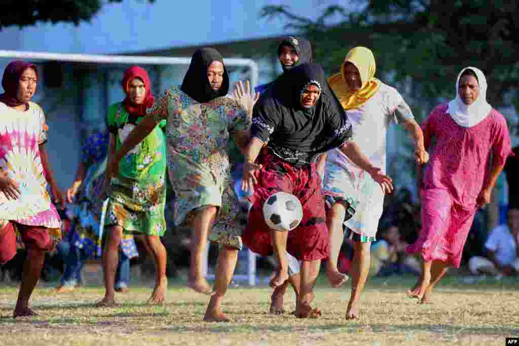 Acehnese men, dressed in woman's clothing, play football to mark the 71st Indonesian Independence Day in Banda Aceh.