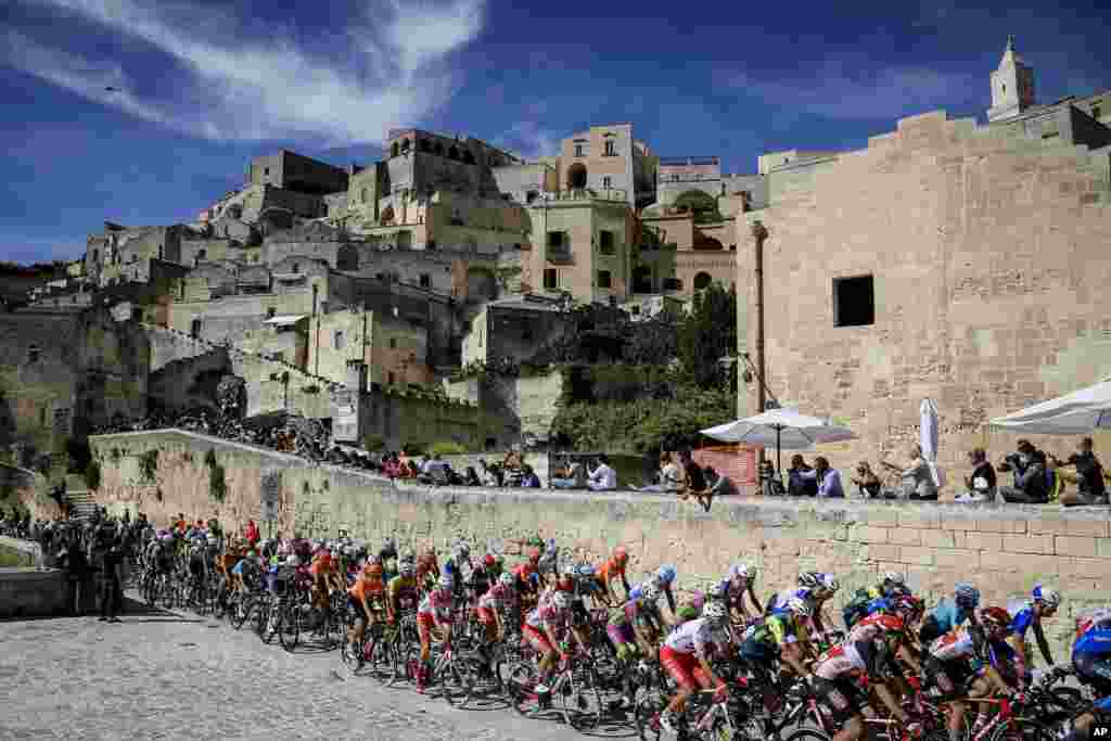 The pack of cyclists pedals past Matera at the start of the seventh stage of the Giro d'Italia cycling race, from Matera to Brindisi, southern Italy.
