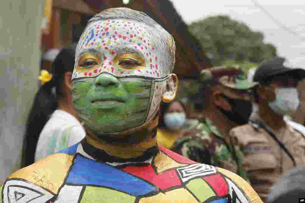 A man participates in the Hindu ritual of "Grebeg" at the Tegalalang village in Bali, Indonesia.
