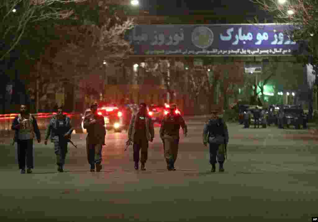 Afghan police forces arrive at the site of a gun battle in Serena Hotel in Kabul, March 20, 2014. 