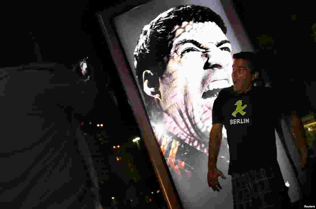 As pessoas acorrem ao muppi da publicidade da marca Adidas "Tudo ou Nada" com a cara de Suarez de boca aberta, pronto a morder. Copacabana, Rio de Janeiro Junho 26, 2014.