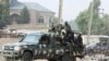 FILE - Nigerian military secure the area where a man was killed by suspected militants during an attack around Polo area of Maiduguri, Nigeria, Feb. 16, 2019. 