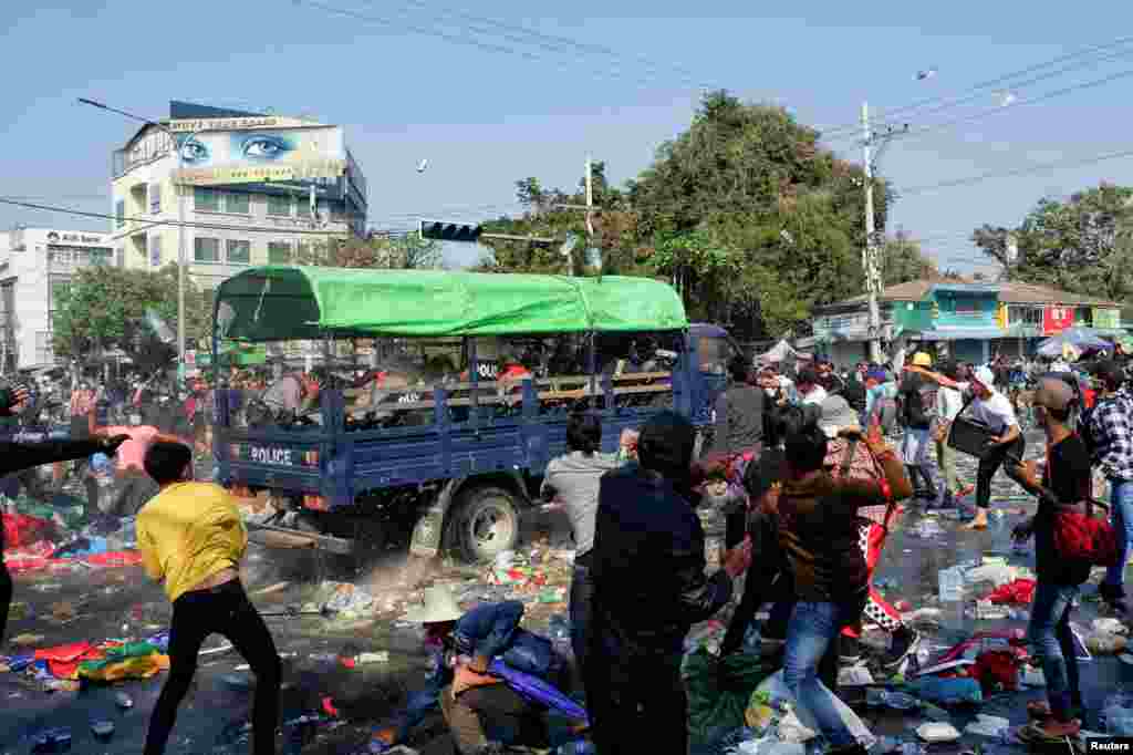 Demonstrators clash with police as they protest against the military coup and to demand the release of elected leader Aung San Suu Kyi, in Mandalay, Myanmar.