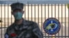 In this Feb. 21, 2020, photo, a South Korean marine wearing a mask stands in front of the Navy Base after a soldier of the unit was confirmed to have been infected with the coronavirus on Jeju Island, South Korea.
