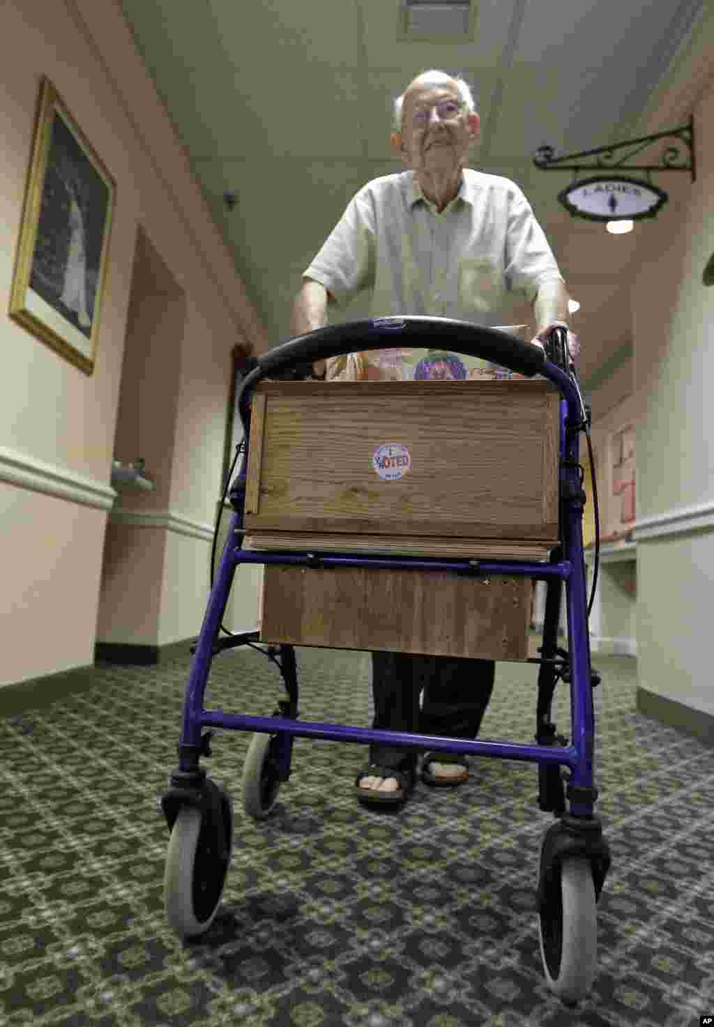 87-year old voter Rolf Kleinwort placed his "I Voted" sticker on the front of his walker as he heads back to his residence at the St. Andrews Estates North retirment community in Boca Raton, Florida.